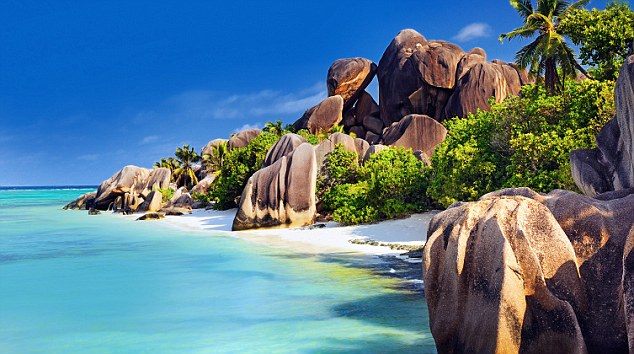 Famous beach Anse Source d'Argent with palm trees and sculpted rocks, La Digue Island, Seychelles, Indian Ocean